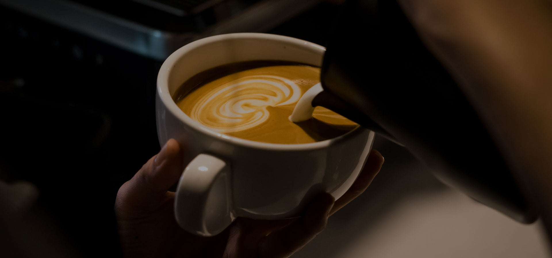 pouring coffee dark background latte art